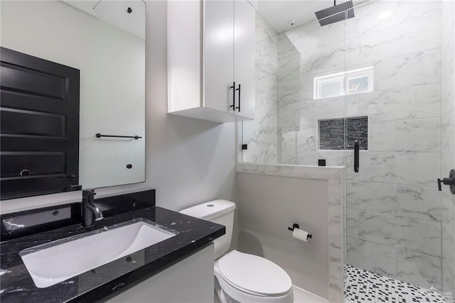 bathroom with vanity, toilet, and an enclosed shower