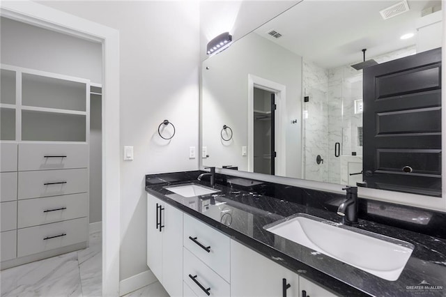 bathroom with vanity and a shower with door