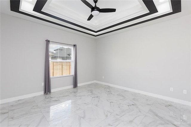 unfurnished room featuring ceiling fan, a raised ceiling, and crown molding