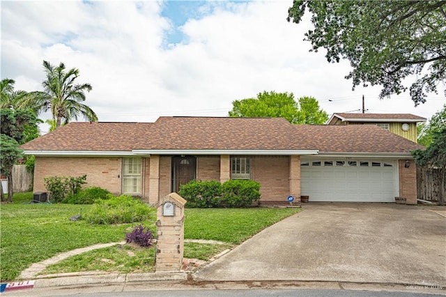 501 W Esperanza Ave, Mcallen, TX 78501 - ranch-style home with concrete driveway, a front lawn, an attached garage, and brick siding