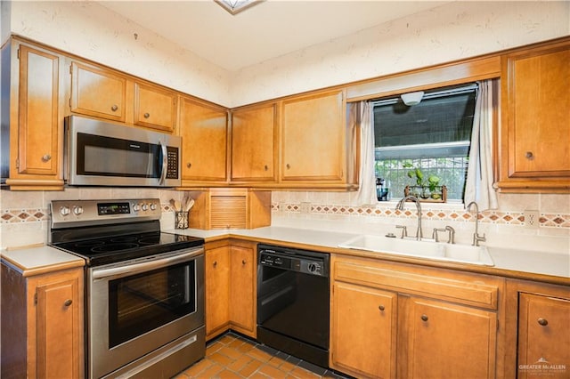 501 W Esperanza Ave, Mcallen, TX 78501 - kitchen with appliances with stainless steel finishes, a sink, light countertops, tasteful backsplash, and brick patterned floors