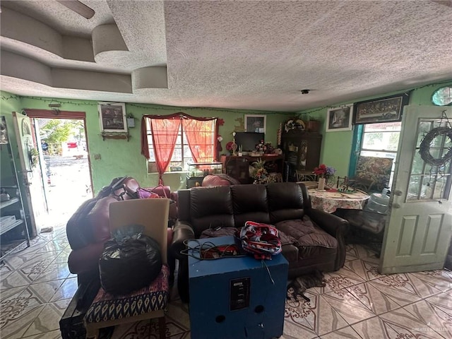 tiled living room featuring a textured ceiling