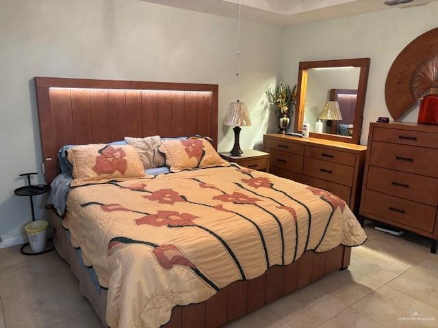 bedroom with light tile patterned floors