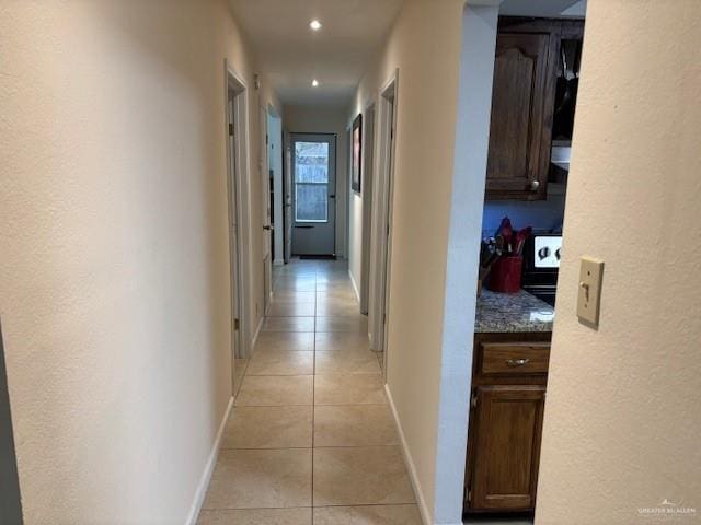 hall featuring light tile patterned flooring