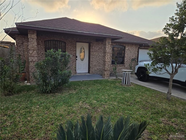 view of front of house with a garage and a lawn