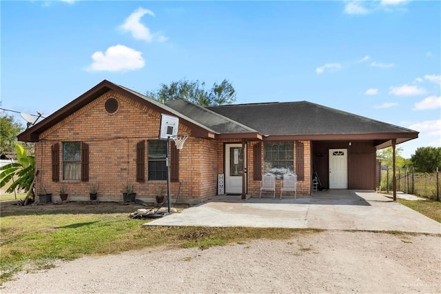 1216 N Stewart Blvd, Mission, TX 78573 - ranch-style house with driveway, brick siding, an attached carport, and a front yard
