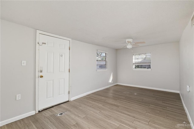 spare room with ceiling fan and light hardwood / wood-style flooring