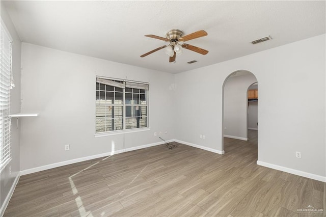 spare room with hardwood / wood-style flooring and ceiling fan