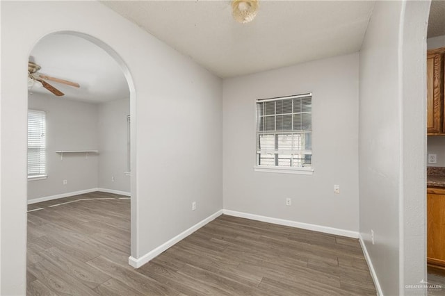 spare room with hardwood / wood-style flooring and ceiling fan