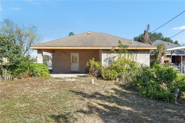 back of property featuring a patio area and a yard