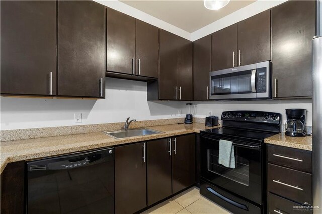 813 Travis St Unit 419, Mission, TX 78572 - kitchen with a sink, light tile patterned floors, black appliances, and dark brown cabinets