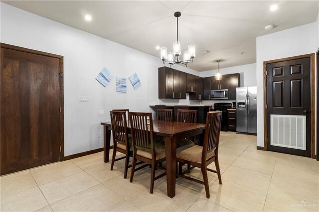 813 Travis St Unit 419, Mission, TX 78572 - dining space with baseboards, a notable chandelier, visible vents, and light tile patterned floors
