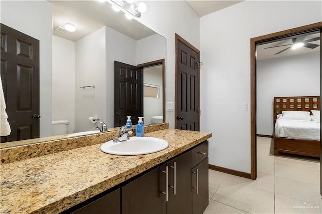 813 Travis St Unit 419, Mission, TX 78572 - ensuite bathroom featuring vanity, toilet, ensuite bathroom, baseboards, and tile patterned floors