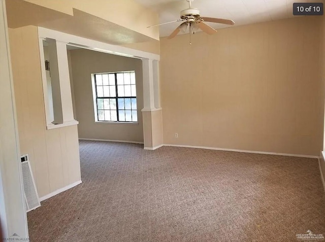 empty room featuring carpet floors, baseboards, visible vents, and a ceiling fan