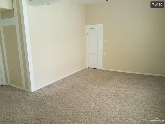 spare room with carpet and baseboards