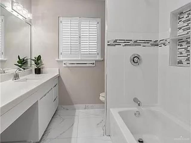 full bathroom featuring sink,  shower combination, and toilet