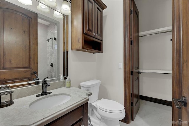 bathroom with tile patterned flooring, vanity, and toilet