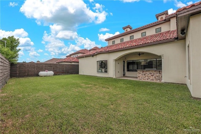 back of house with a lawn and a patio area