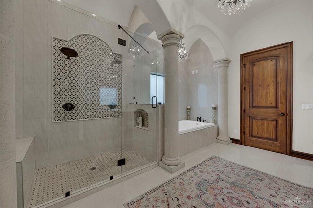 bathroom with tile patterned flooring, separate shower and tub, lofted ceiling, and decorative columns