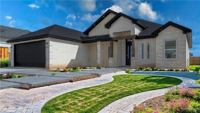 view of front of property with a garage and a front yard