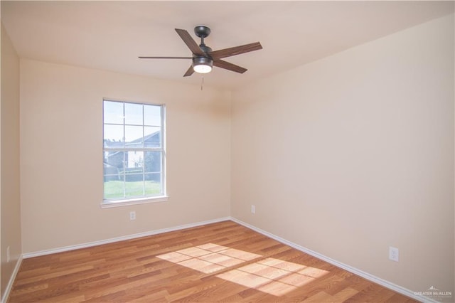 spare room with ceiling fan and light wood-type flooring