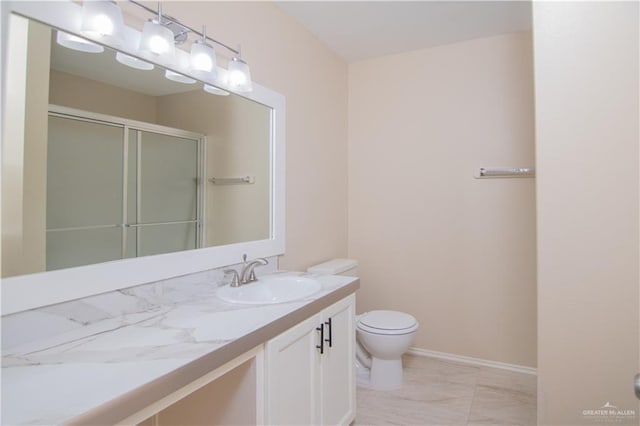 bathroom featuring vanity, toilet, and an enclosed shower