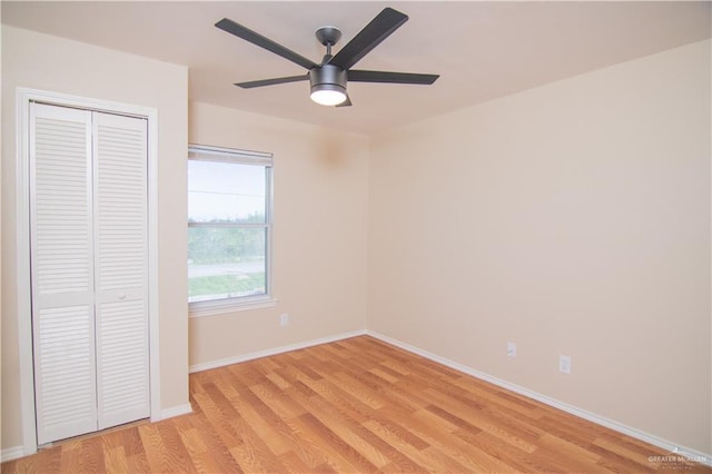 unfurnished bedroom with ceiling fan, a closet, and light hardwood / wood-style flooring