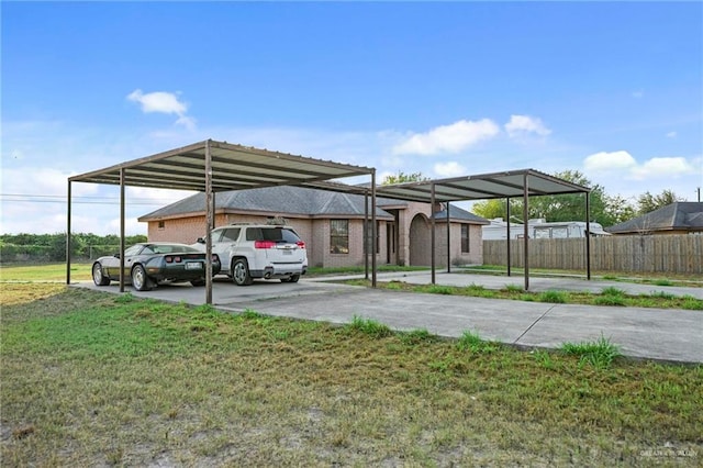 view of parking featuring a lawn and a carport