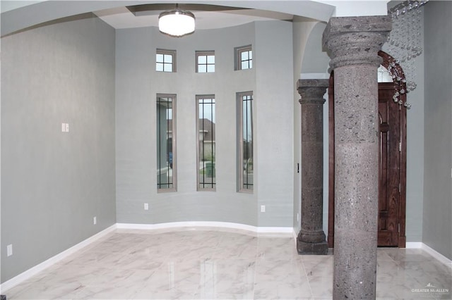 spare room with decorative columns