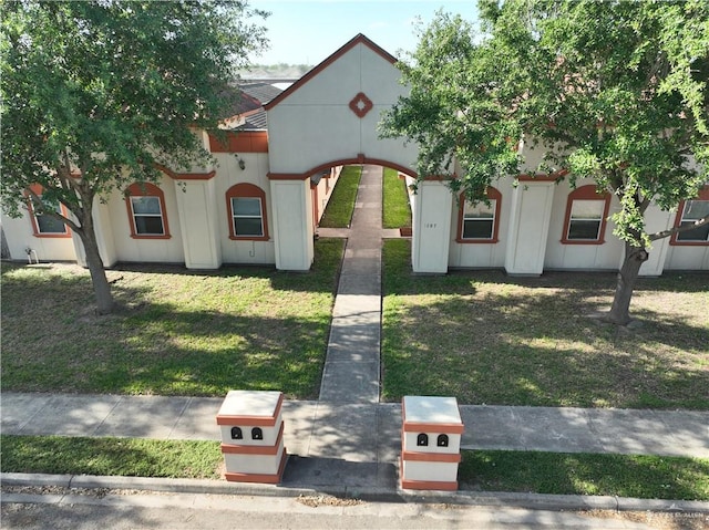 mediterranean / spanish house with a front yard