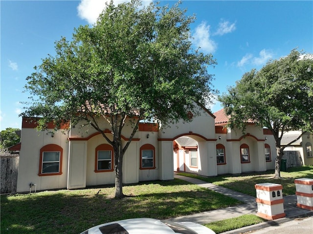 mediterranean / spanish house with a front lawn