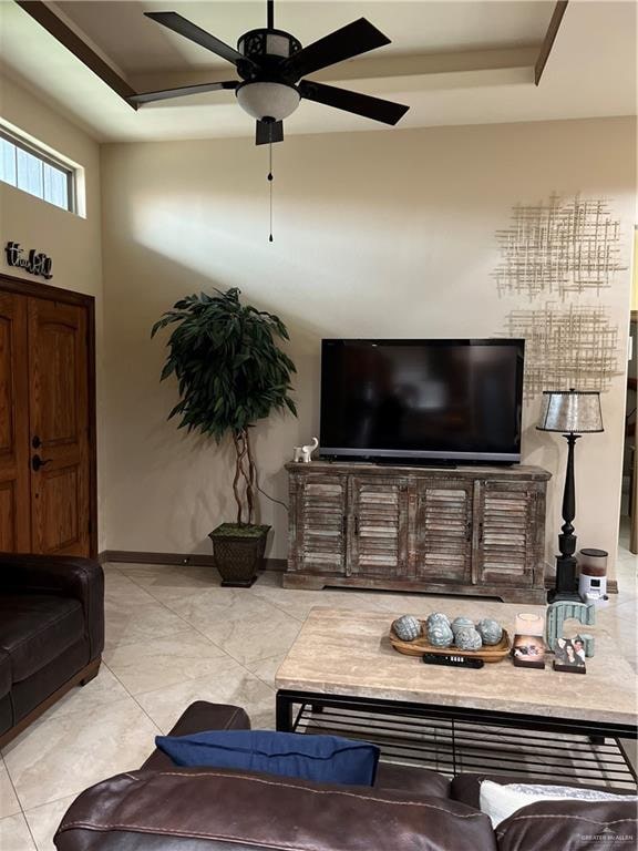 tiled living room featuring ceiling fan