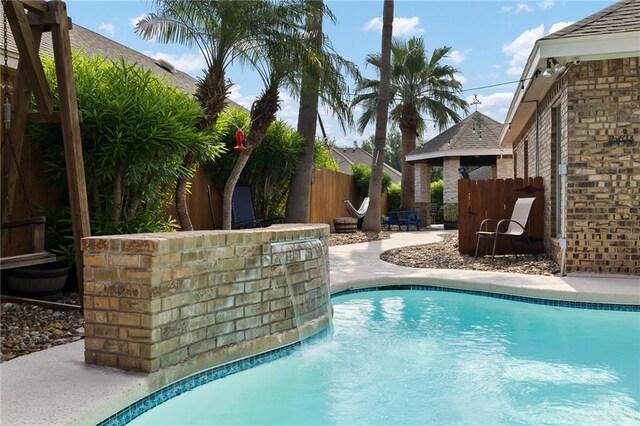 view of pool with fence and a patio area