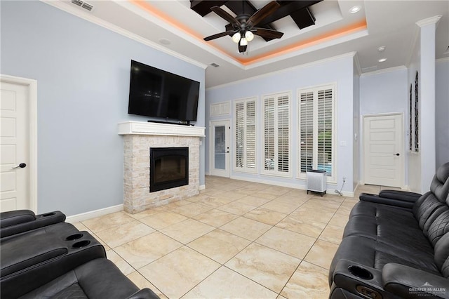living area with ceiling fan, a raised ceiling, ornamental molding, a fireplace, and light tile patterned floors