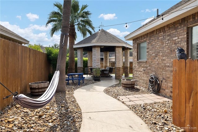 view of yard featuring a gazebo, fence, and a patio area