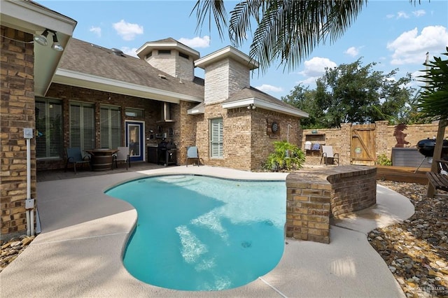 view of pool featuring a patio, a gate, and fence