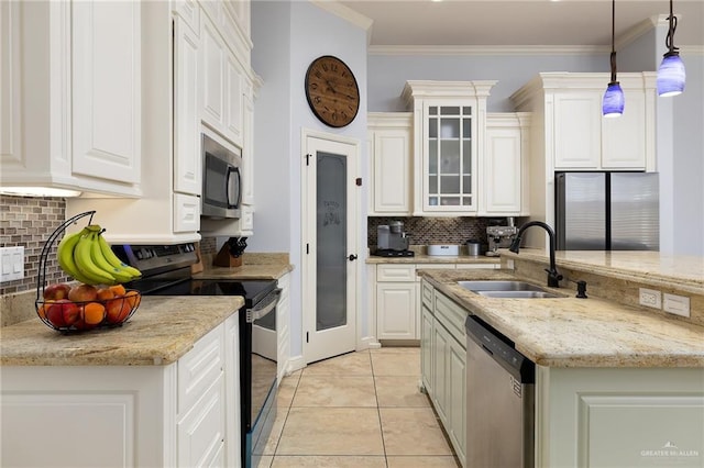 kitchen with appliances with stainless steel finishes, a sink, backsplash, decorative light fixtures, and white cabinetry