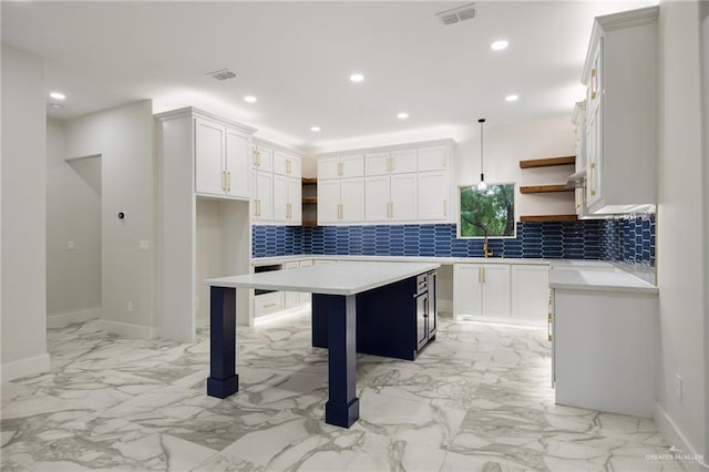 2313 Champion Ave, Donna, TX 78537 - kitchen with decorative backsplash, a kitchen island, white cabinetry, and hanging light fixtures