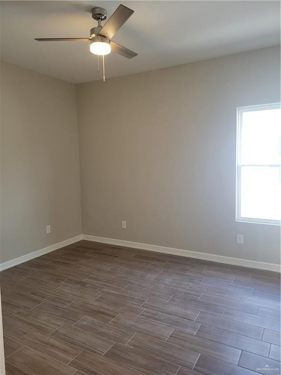 empty room with wood tiled floor, baseboards, and a ceiling fan