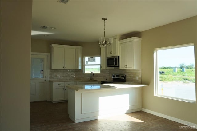 kitchen featuring stainless steel appliances, a sink, white cabinetry, decorative backsplash, and dark wood-style floors