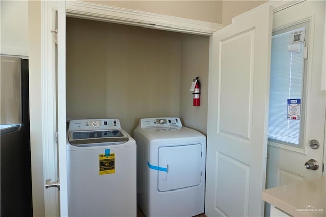 laundry area with laundry area and independent washer and dryer