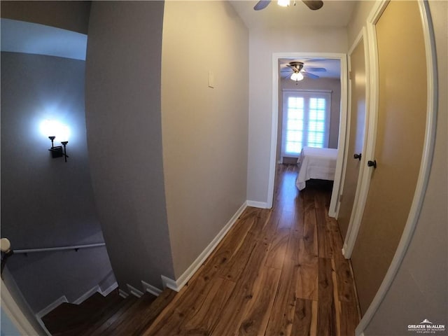 hall featuring wood finished floors and baseboards
