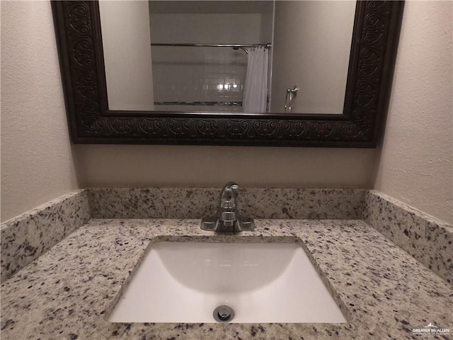 bathroom featuring vanity and a shower with shower curtain