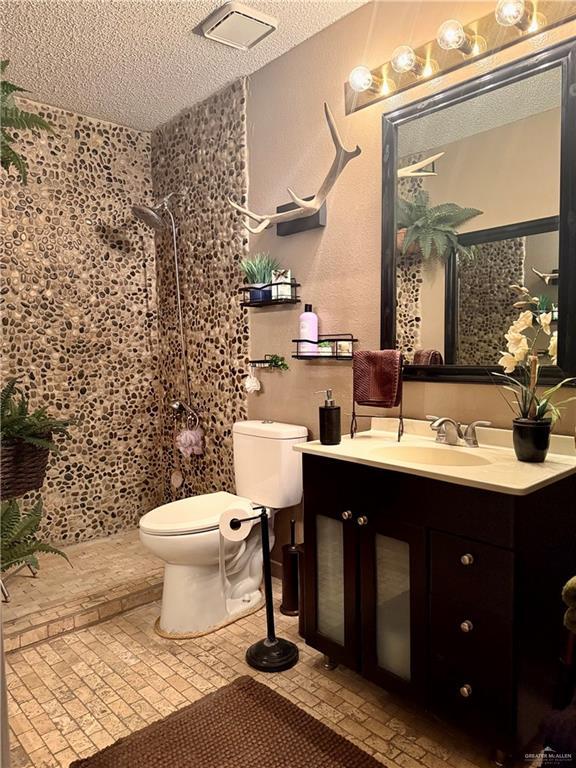 2612 Ashley Dr, Pharr, TX 78577 - full bath with a textured ceiling, a shower, and vanity