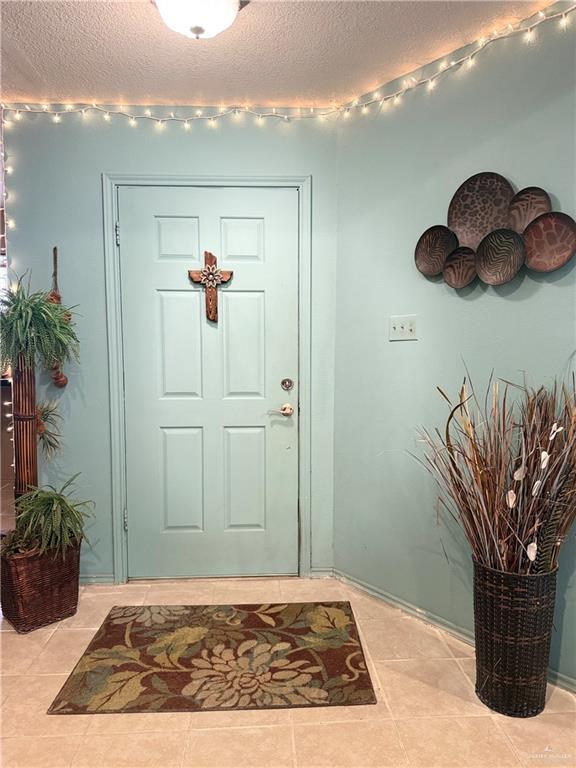2612 Ashley Dr, Pharr, TX 78577 - entrance foyer featuring a textured ceiling and light tile patterned flooring