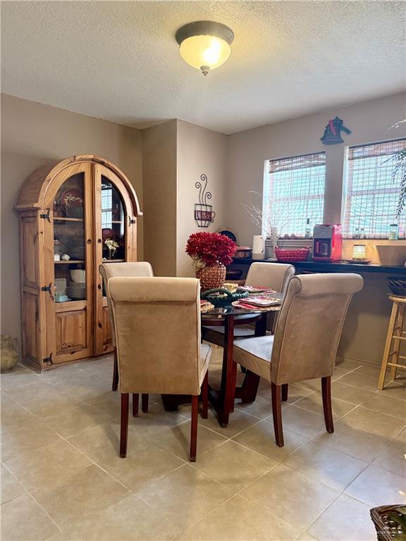 2612 Ashley Dr, Pharr, TX 78577 - dining space featuring a textured ceiling and light tile patterned flooring