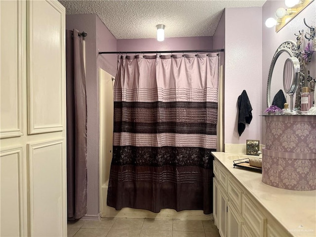 2612 Ashley Dr, Pharr, TX 78577 - bathroom featuring tile patterned floors, vanity, a textured ceiling, and shower / tub combo