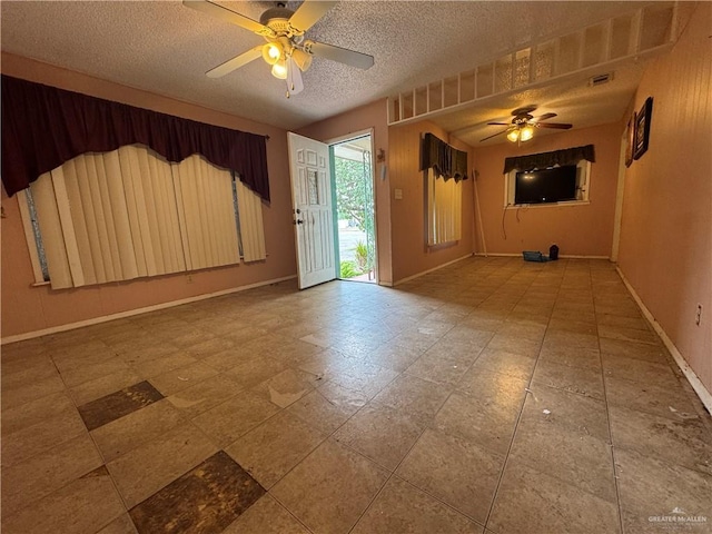 814 N Pino St, Weslaco, TX 78596 - spare room with a ceiling fan, baseboards, and a textured ceiling
