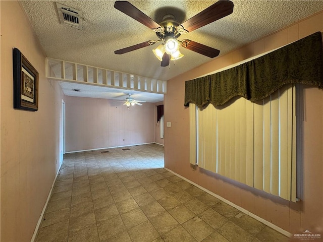 814 N Pino St, Weslaco, TX 78596 - unfurnished room featuring a ceiling fan, a textured ceiling, and baseboards