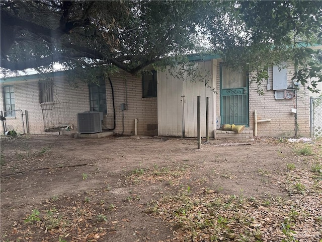 814 N Pino St, Weslaco, TX 78596 - rear view of property with cooling unit and brick siding